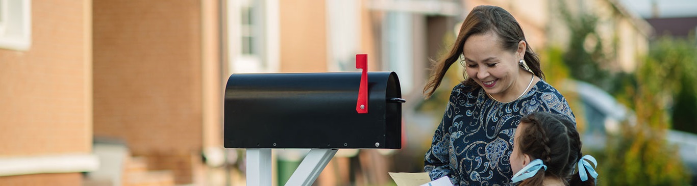 Woman getting mail from mailbox